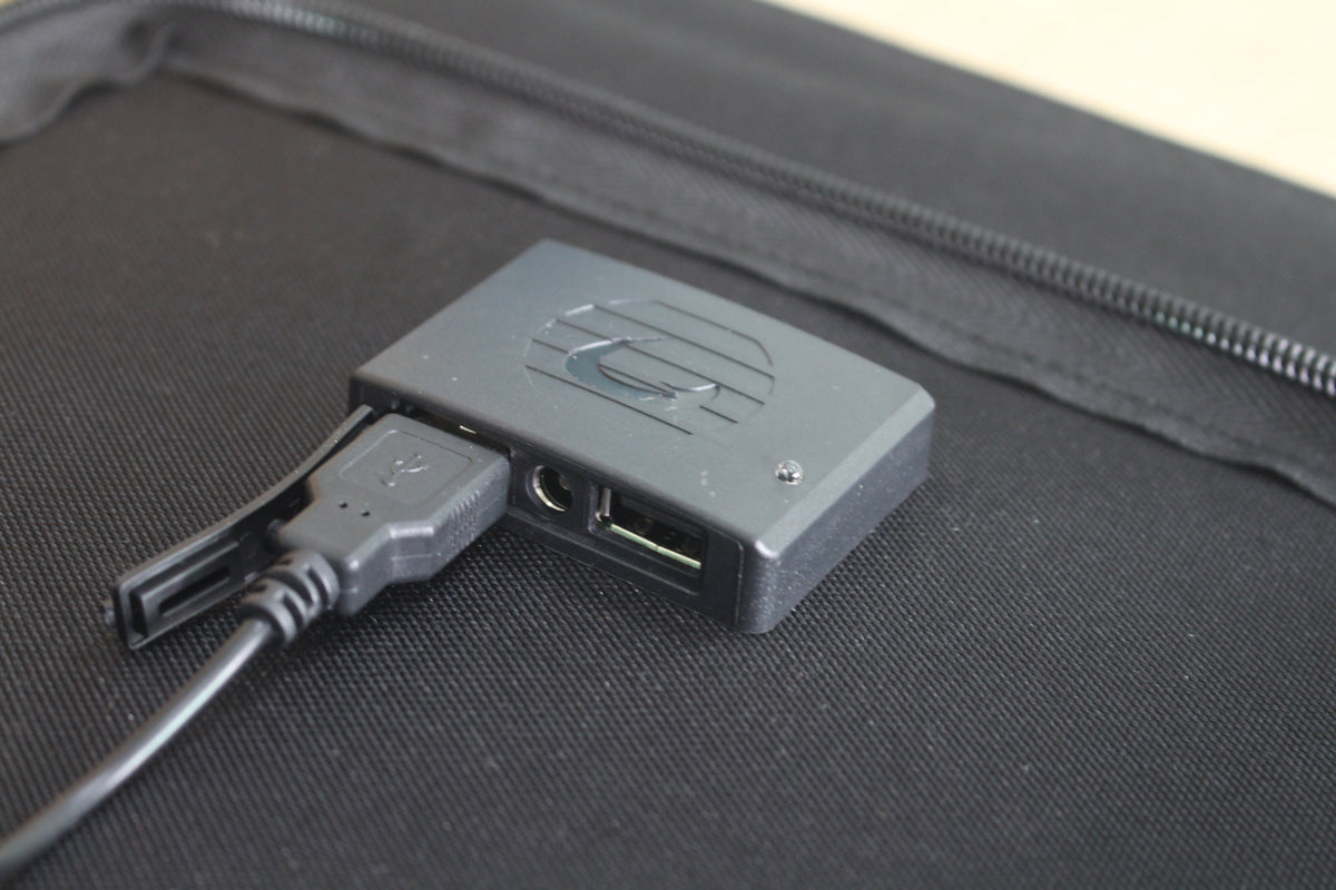 ACOPOWER 100W solar panel charging a portable power station outdoors on grass