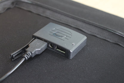 ACOPOWER 100W solar panel charging a portable power station outdoors on grass