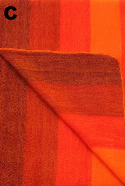 Closeup of the orange striped alpaca blanket's woven texture