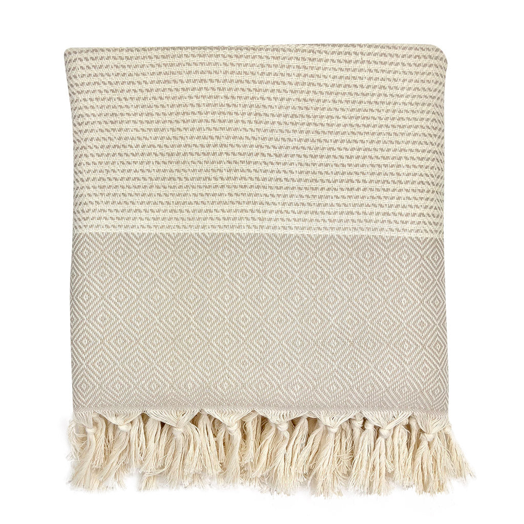 Folded beige and cream diamond stripe Turkish throw with knotted tassel fringe
