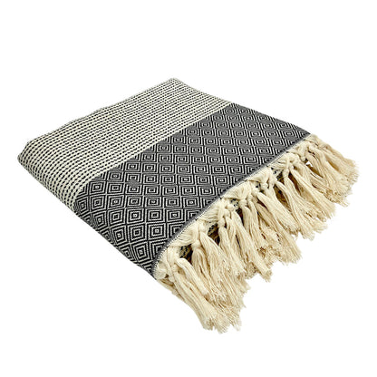 Folded black and white diamond stripe Turkish throw with thick cream tassel fringe