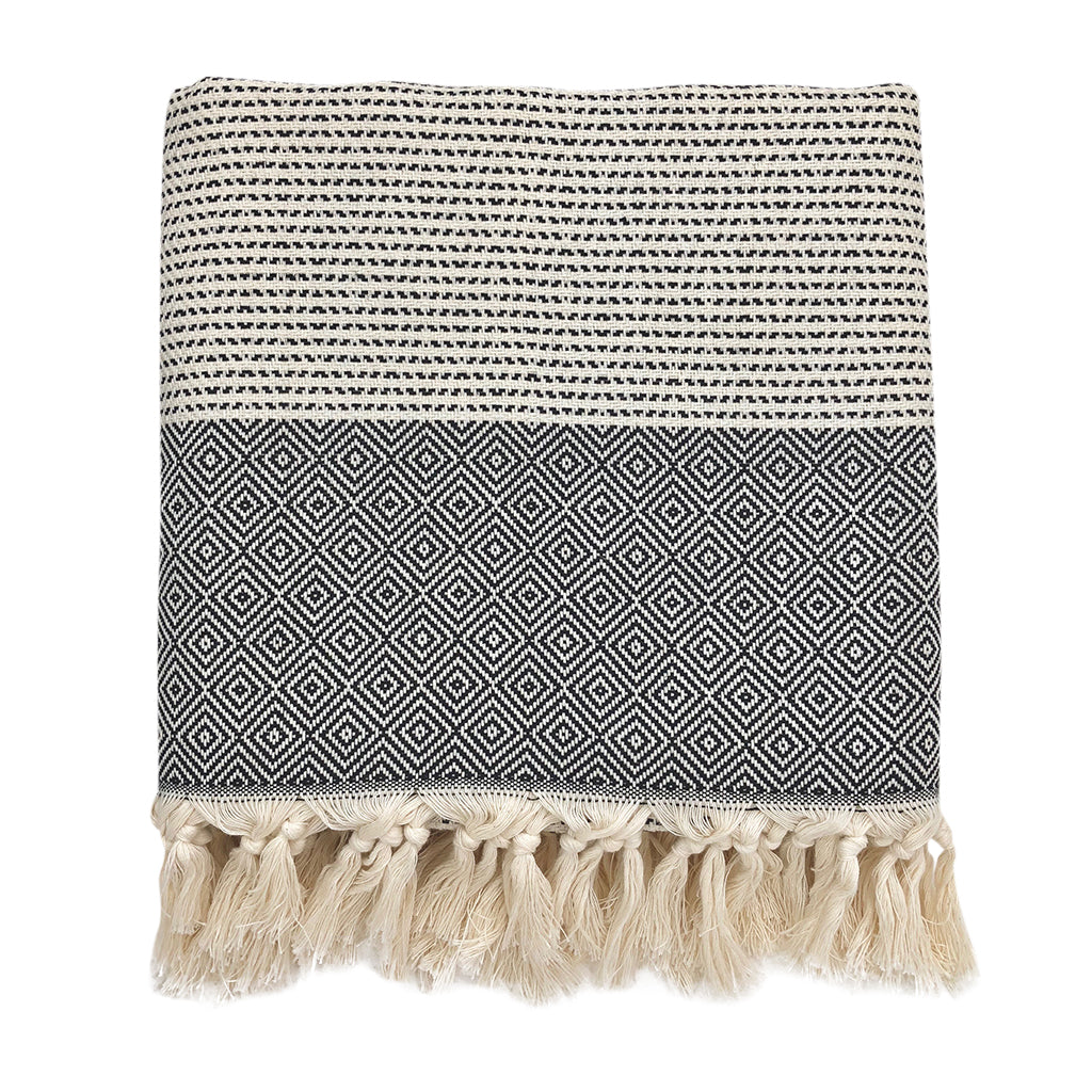 Folded black and cream diamond stripe Turkish throw with knotted fringe