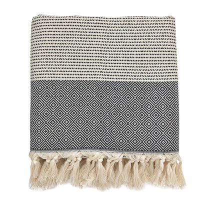 Folded black and cream diamond stripe Turkish throw with knotted fringe