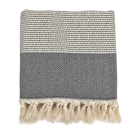 Folded black and cream diamond stripe Turkish throw with knotted fringe