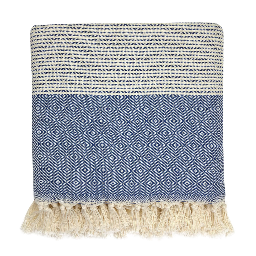 Folded navy blue and cream diamond stripe Turkish throw with cream tassel fringe