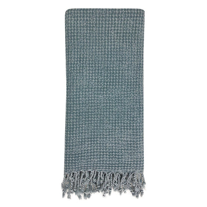 Folded teal blue waffle weave Turkish towel with tassel fringe