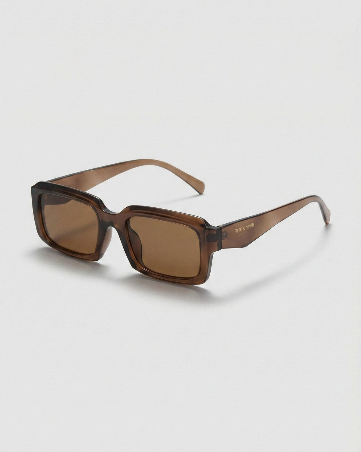 Fifth & Ninth Danni unisex polarized sunglasses with a translucent brown rectangular frame and brown lenses, angled side view