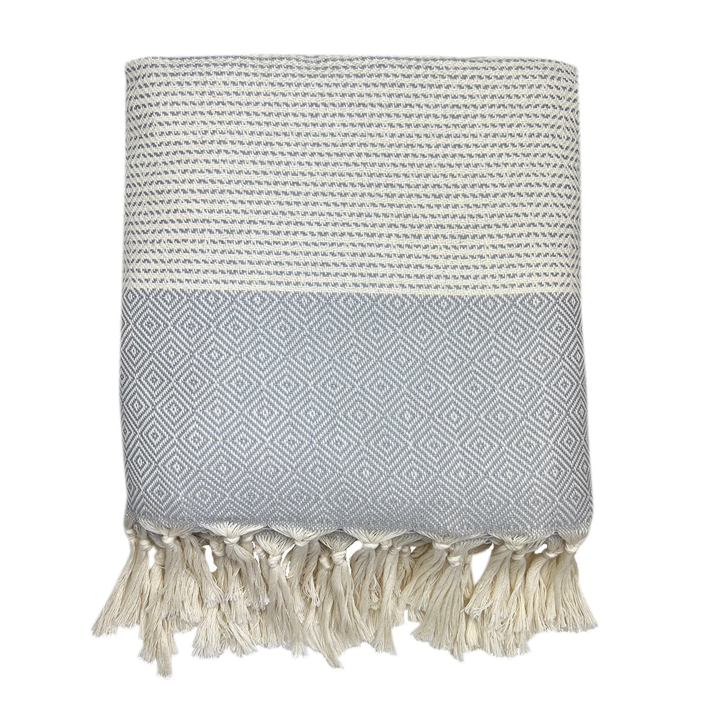 Folded light gray and cream diamond stripe Turkish throw with cream tassel fringe