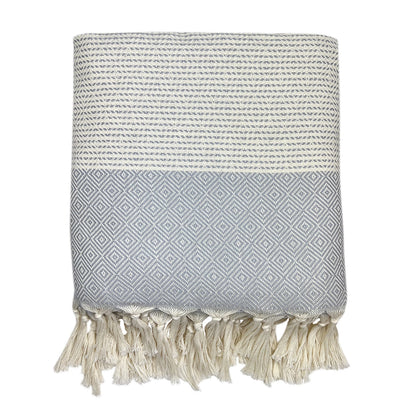 Folded light gray and cream diamond stripe Turkish throw with cream tassel fringe