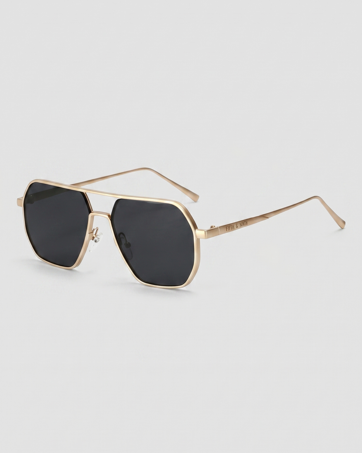 Fifth & Ninth Nola polarized aviator sunglasses with a gold frame and black lenses, angled side view