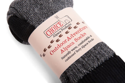 Closeup of dark gray OutdoorAdventure alpaca socks in their Choice Alpaca Products paper band