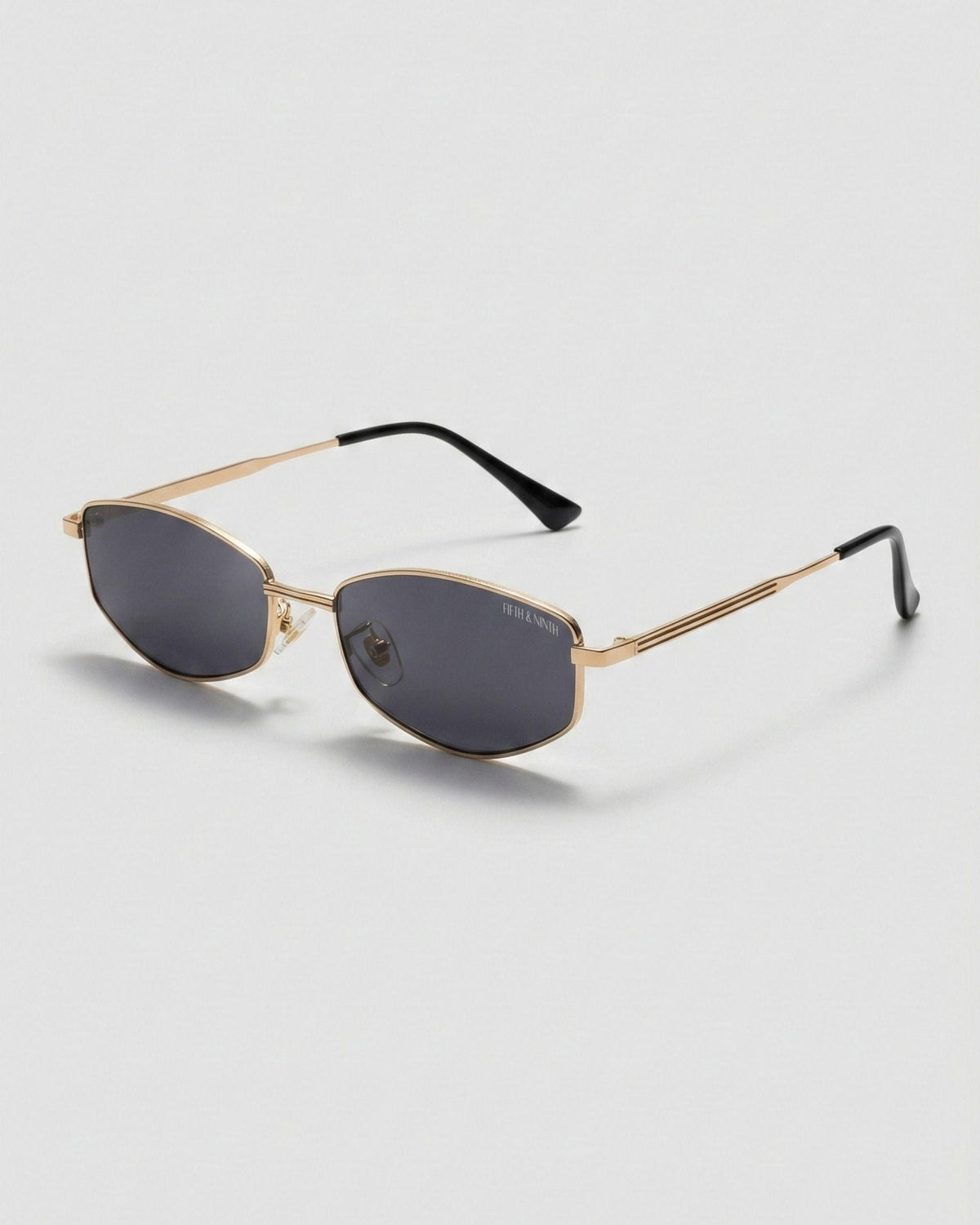 Fifth & Ninth Rowan polarized sunglasses with a gold geometric frame and dark lenses, angled side view
