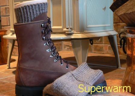 Brown hiking boot and a folded gray Superwarm alpaca sock with a Superwarm text overlay