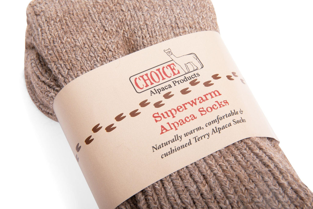 Closeup of brown Superwarm alpaca socks in their Choice Alpaca Products paper band